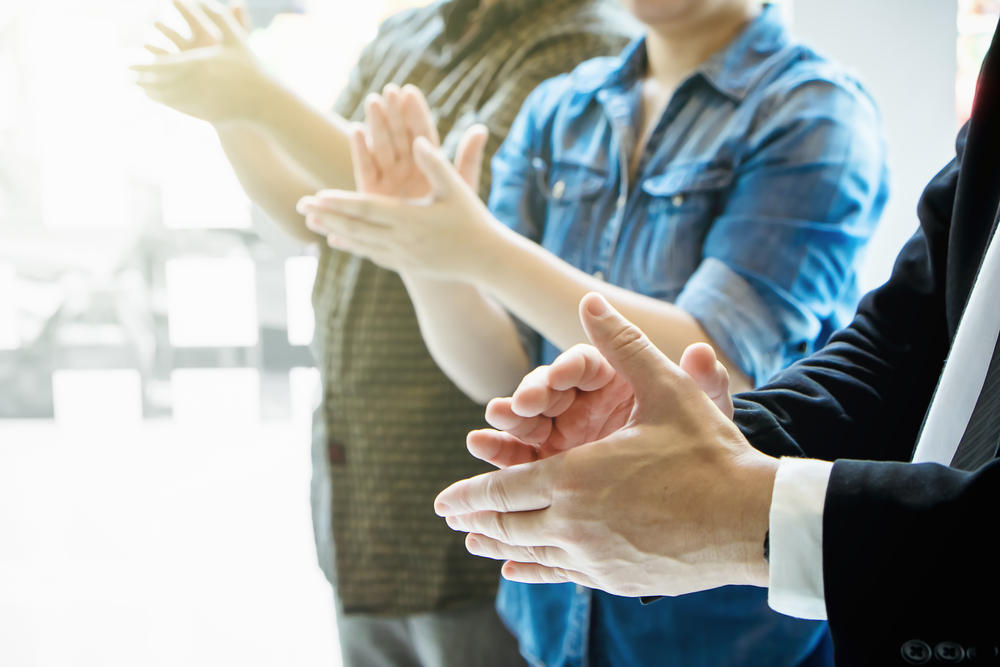 team members clapping hands