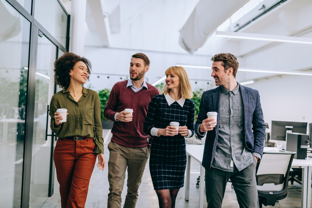 group of employees laughing with coffee