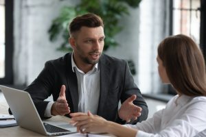 boss in meeting with employee having discussion