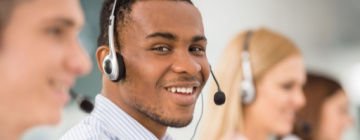 african american customer service agent on phone with headset on