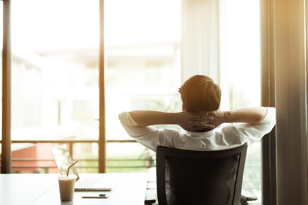 man sitting in office chair at desk