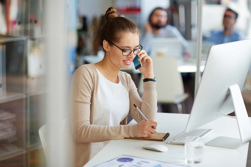 woman on phone with customer in office