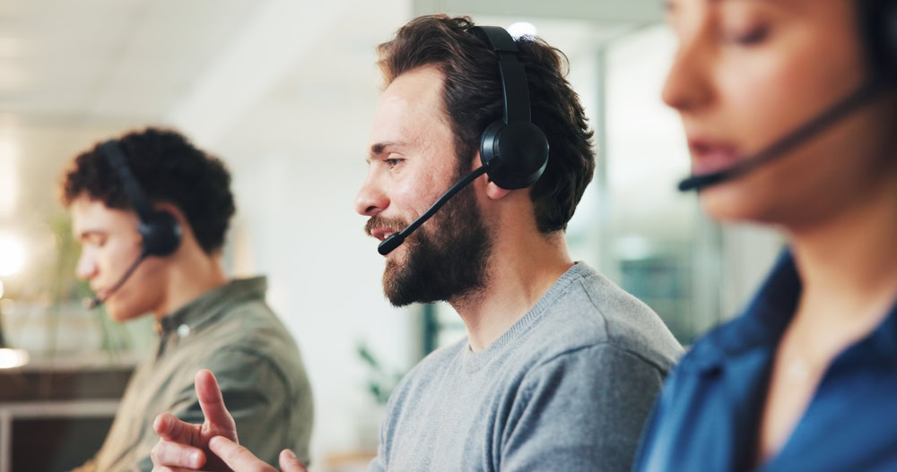 Customer support agents using headsets collaborate and use small talk to improve customer calls and build rapport