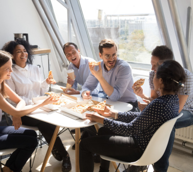 Employees celebrate with a pizza party