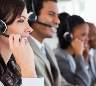 call center workers smiling as they talk to customers