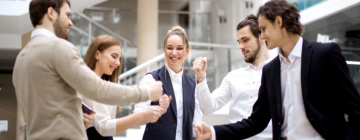 Group of employees giving fist bumps