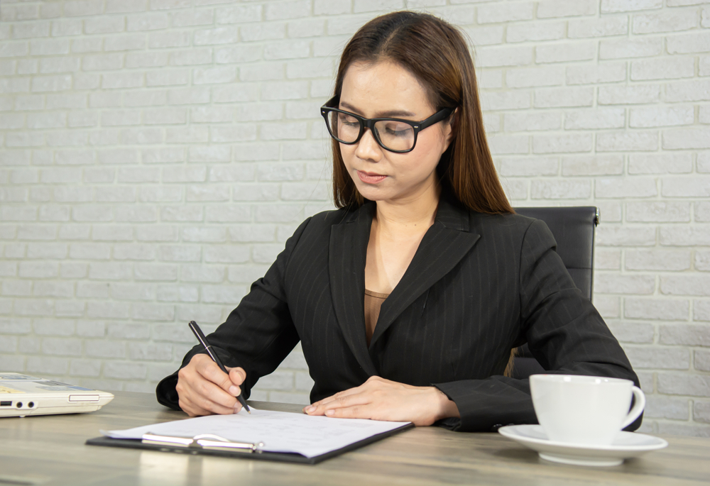 Young woman works on writing a great resume