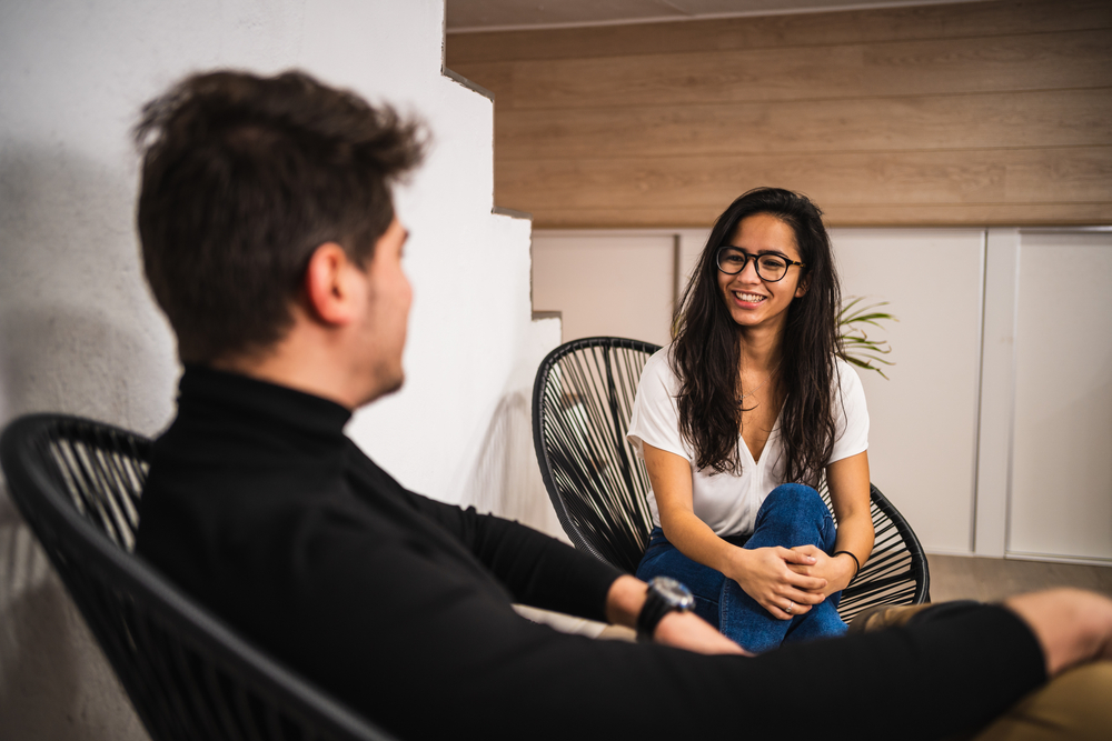 Hispanic employees sit and talk on their break