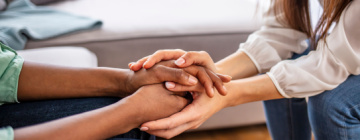 image of hands clasping, mental health at work concept