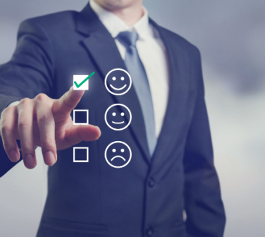 Businessman torso and hand choosing a smiling face review