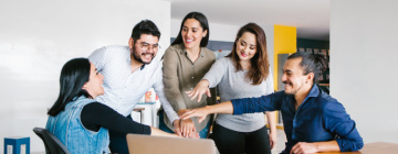 Team of Latino coworkers build motivation