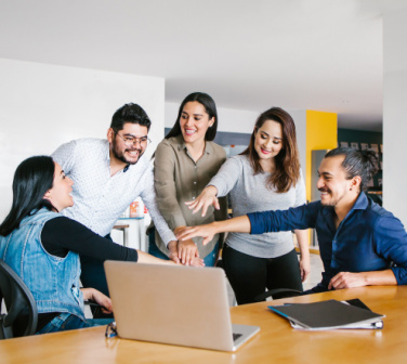 Team of Latino coworkers build motivation