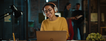 Young Hispanic woman listens to a customer through headset