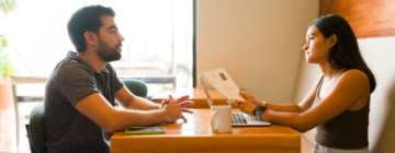 A female recruiter interviews a male job applicant