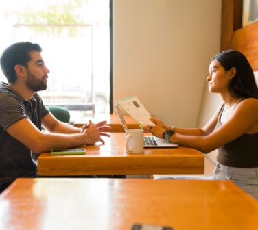 A female recruiter interviews a male job applicant