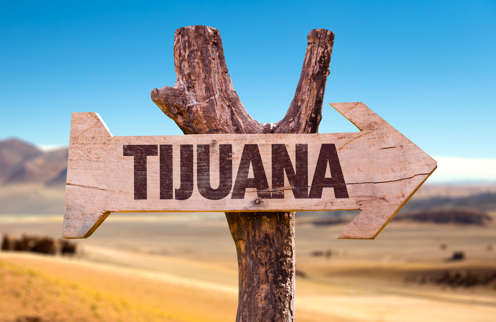 Wooden sign pointing the way to Tijuana