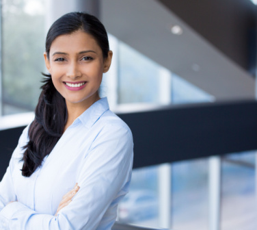 Young professional Hispanic woman smiles at camera - customer service jobs in Mexico