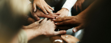 A group of diverse hands meeting in the middle - customer diversity in the call center