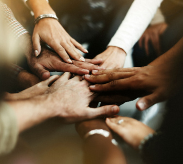 A group of diverse hands meeting in the middle - customer diversity in the call center