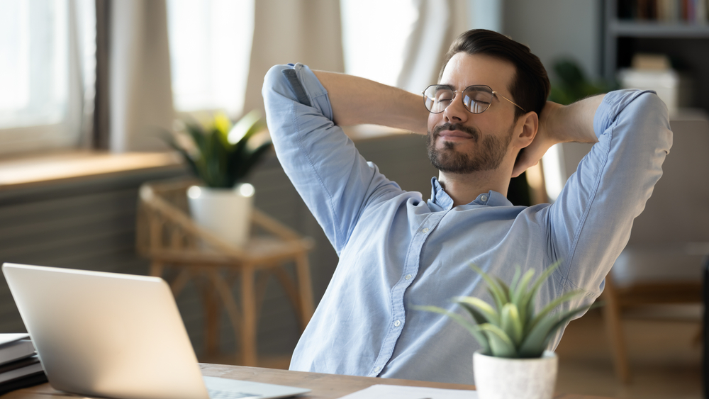 Man leaning back in his chair with his eyes closed