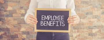 Call center worker holding a sign that has employee benefits written on it, concept of employee benefits, best call center in Tijuana