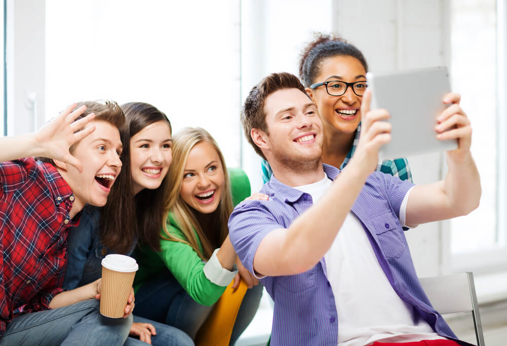 Call center co-workers take a selfie while having fun at work.