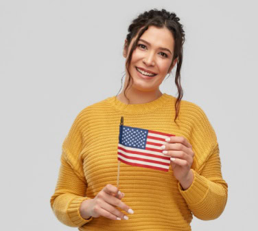 Woman holding a U.S. flag and smiling, symbolizing bilingual speakers connected to American culture and language-1