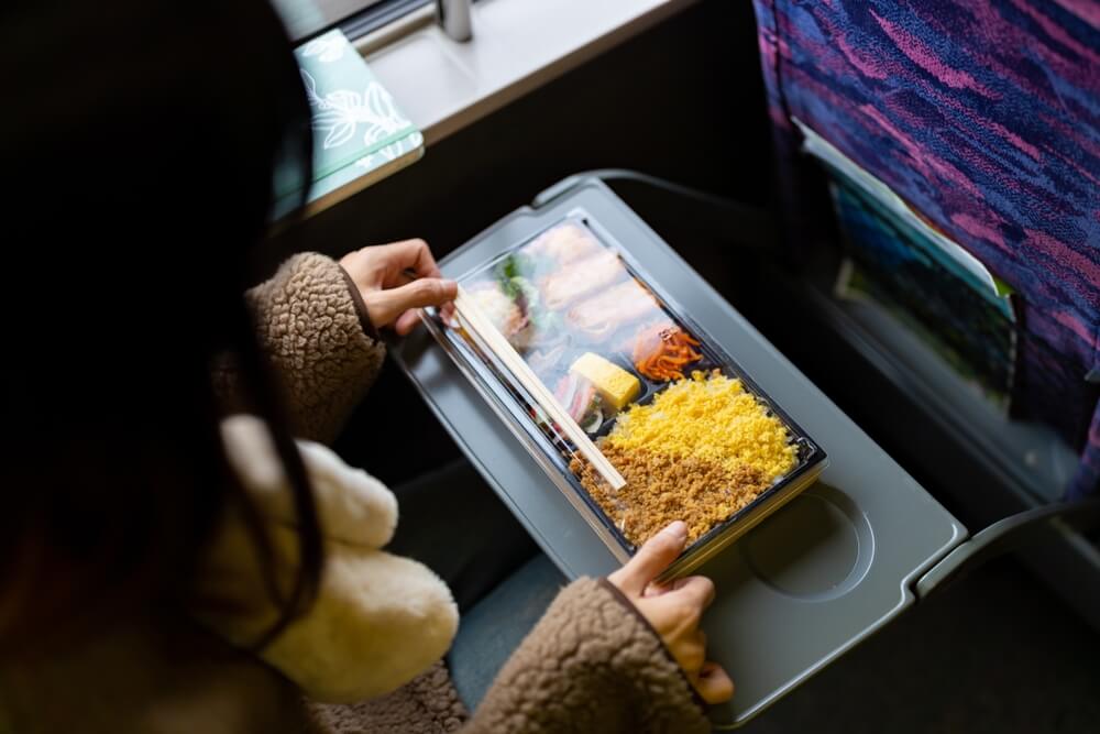 Young woman prepares to eat a traditional Bento Box for lunch - best call center in Tijuana.