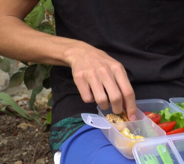 Young man eats a Bento Box for lunch - best call center in Tijuana.