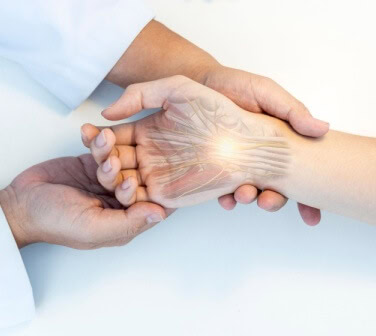 A medical professional examines a hand with graphics to show carpal tunnel - best call center in Tijuana.