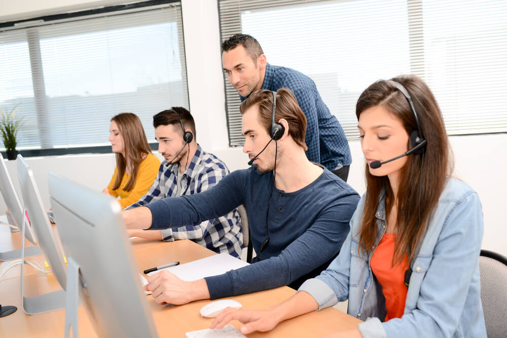 A group of call center employees receives continuous training for their customer service skills - best call center jobs in Tijuana.