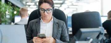 Call center employee is distracted from work by phone - Seguros Confie, Best Call Center in Tijuana.