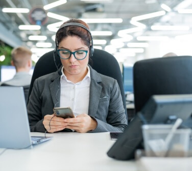 Call center employee is distracted from work by phone - Seguros Confie, Best Call Center in Tijuana.