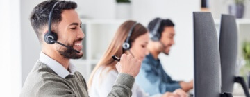 Man working in a call center with a group of people - Seguros Confie, Best Call Center in Tijuana.