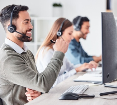 Man working in a call center with a group of people - Seguros Confie, Best Call Center in Tijuana.