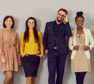 Smiling business people in a line showing appropriate dress for success.