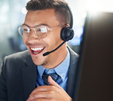 Hispanic customer service rep smiling with glasses on.