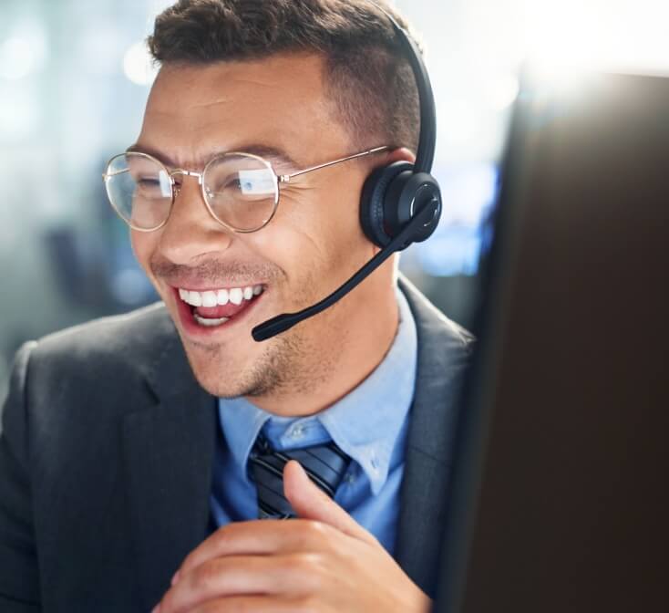 Hispanic customer service rep smiling with glasses on.