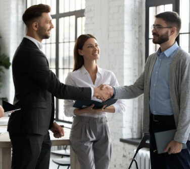 New employee shaking hands and meeting the team - best call center jobs in Tijuana.
