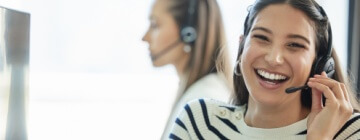 Smiling call center worker helps an angry customer - best call center job in Tijuana.