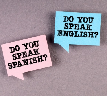 Two signs on a background saying do you speak English do you speak Spanish, illustration of bilingual - best call center in Tijuana.