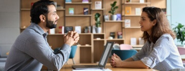 Male HR specialist manager, employer, boss listening to female candidate at her first job interview. Hiring and employment, human resources, recruitment concept.