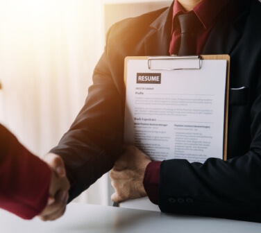 Close up view of job interview in office, focus on resume writing tips, employer reviewing good cv of prepared skilled applicant, recruiter considering application, HR manager making hiring decision for best call center in Tijuana.