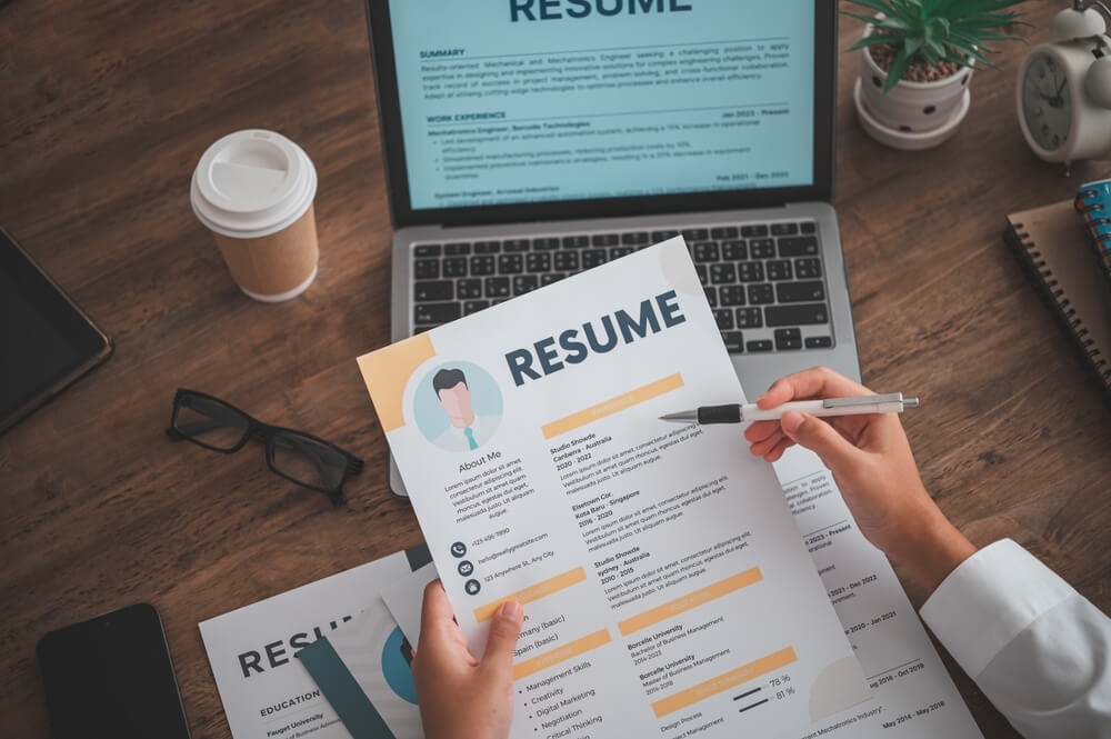 People are reviewing job applications before filling out their resume on the job application form in order to apply for a job at a cool call center in Tijuana.