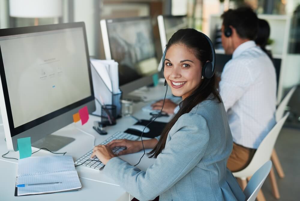 Portrait of a happy and confident young woman working in a call center.