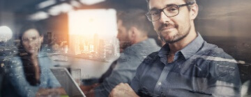 Carving his own career path. Multiple exposure shot of businesspeople in an office superimposed on a cityscape.
