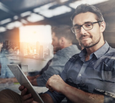 Carving his own career path. Multiple exposure shot of businesspeople in an office superimposed on a cityscape.