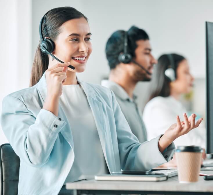 A woman agent with problem-solving skills in call center jobs, smiling as she attends to a customer.