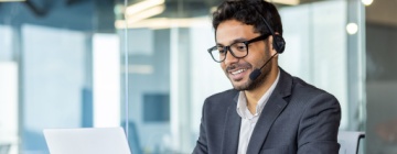 A professional call center agent working on a laptop with a headset, representing call center global careers in an international business environment-1