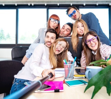 Young people call center employee workers taking happy selfie with stick, life style concept of call center social perks.